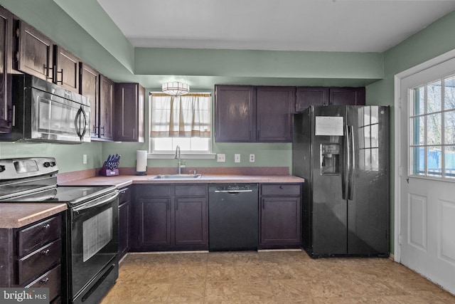 kitchen featuring sink, a wealth of natural light, black appliances, and dark brown cabinetry