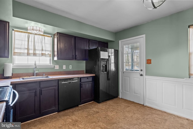 kitchen with sink, black appliances, and dark brown cabinetry