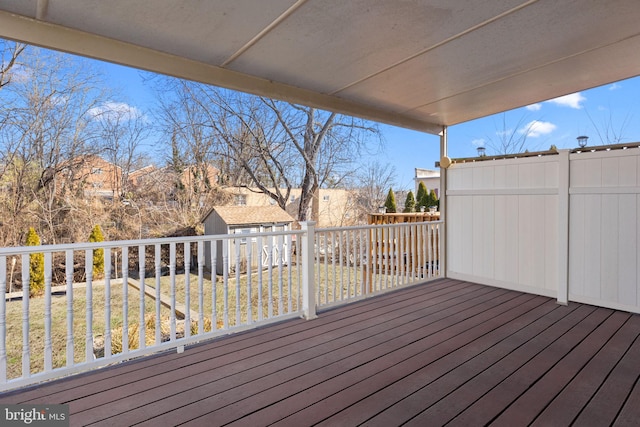 wooden terrace featuring a lawn