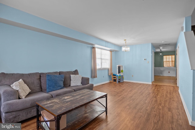 living room with a chandelier and hardwood / wood-style flooring