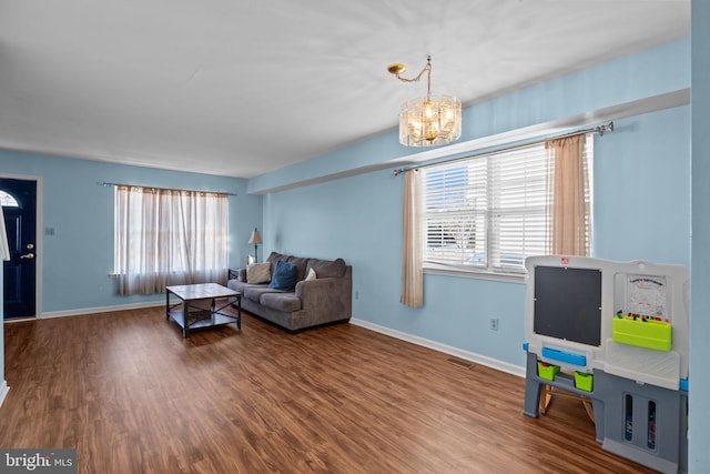 living room with a chandelier and wood-type flooring