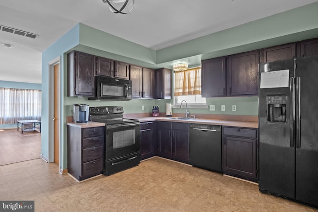 kitchen with black appliances, sink, and dark brown cabinetry