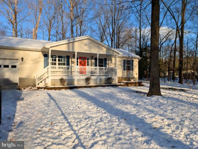 ranch-style house with a garage and covered porch