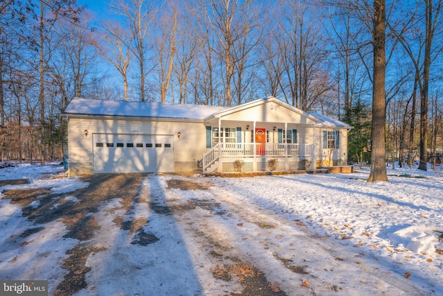 ranch-style house with a garage and a porch