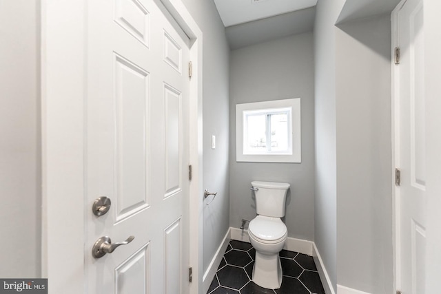 bathroom featuring tile patterned flooring and toilet