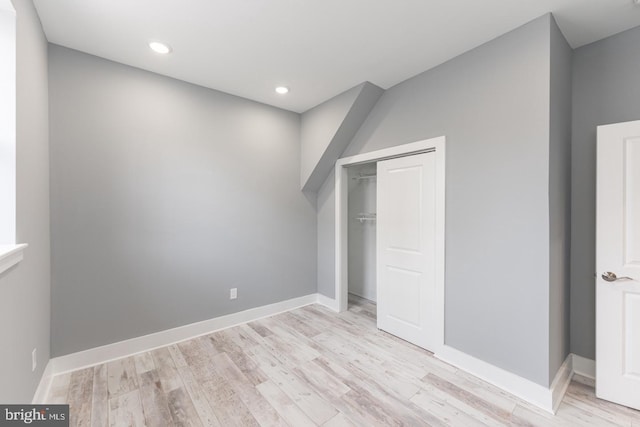 unfurnished bedroom with light hardwood / wood-style floors and a closet