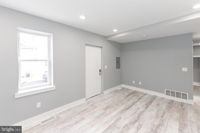 spare room with light wood-type flooring and electric panel