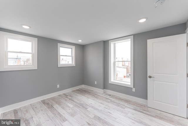 empty room with light hardwood / wood-style floors