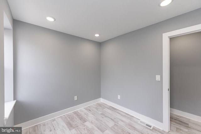 unfurnished room with light wood-type flooring