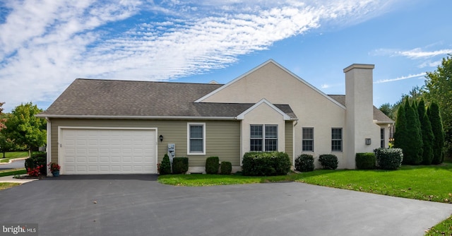 view of front of house with a front lawn and a garage