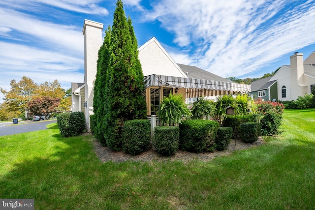 view of side of property with a yard