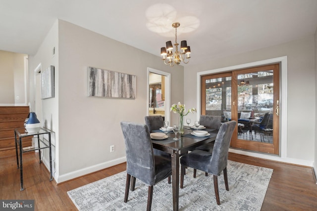 dining space with a chandelier and hardwood / wood-style floors