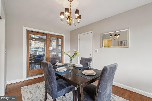 dining area with a chandelier and hardwood / wood-style flooring