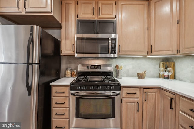 kitchen with decorative backsplash, appliances with stainless steel finishes, and light brown cabinetry