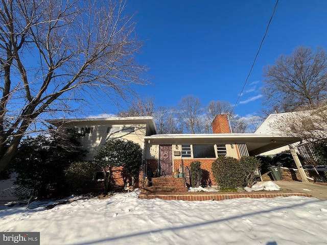 split level home featuring a carport