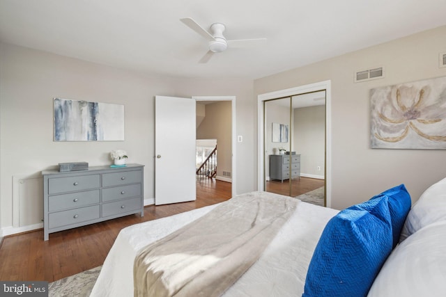 bedroom featuring ceiling fan, a closet, and dark wood-type flooring