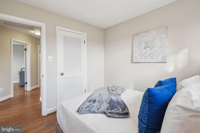 bedroom with dark wood-type flooring