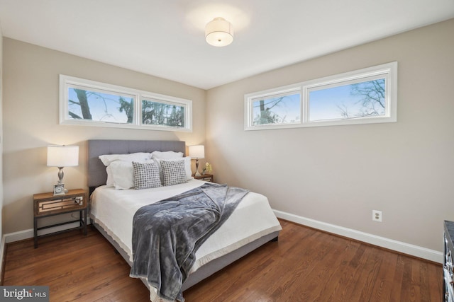 bedroom with dark hardwood / wood-style floors