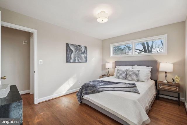 bedroom with dark hardwood / wood-style flooring