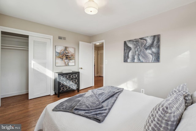 bedroom with a closet and dark hardwood / wood-style flooring