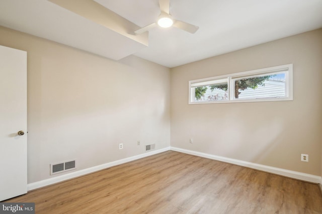 empty room featuring ceiling fan and light hardwood / wood-style floors