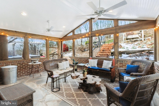 sunroom / solarium with lofted ceiling and ceiling fan