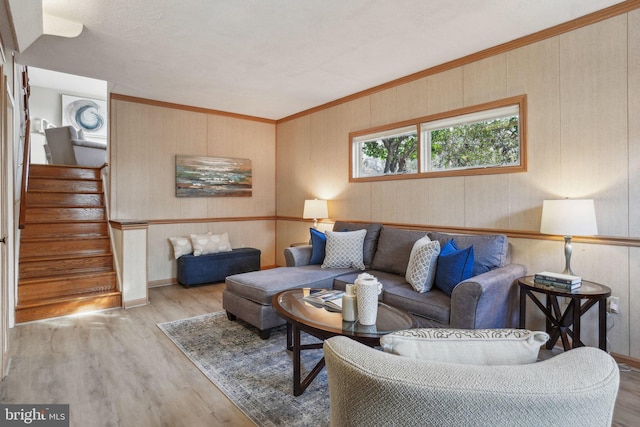 living room featuring crown molding and light hardwood / wood-style floors