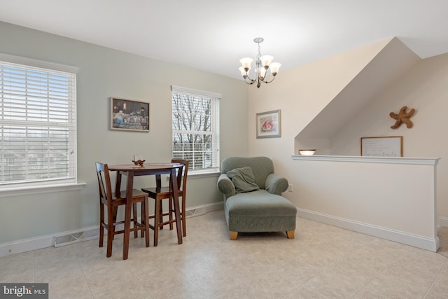 sitting room with light tile patterned floors, an inviting chandelier, and a wealth of natural light