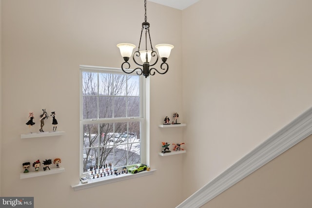 interior details featuring an inviting chandelier