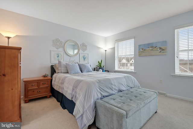 bedroom featuring light colored carpet