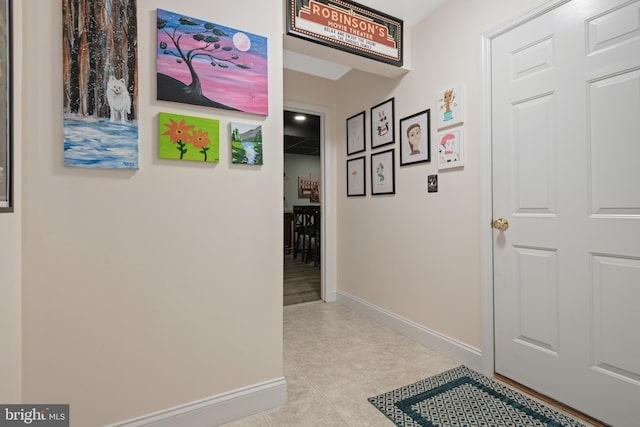 corridor featuring light tile patterned floors