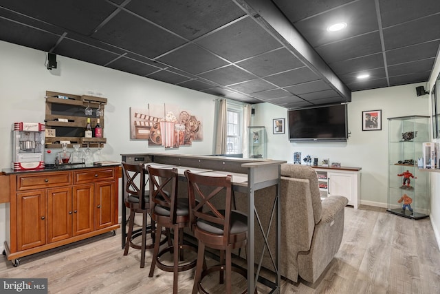 bar featuring light wood-type flooring