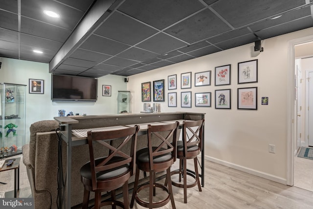 bar with light hardwood / wood-style flooring