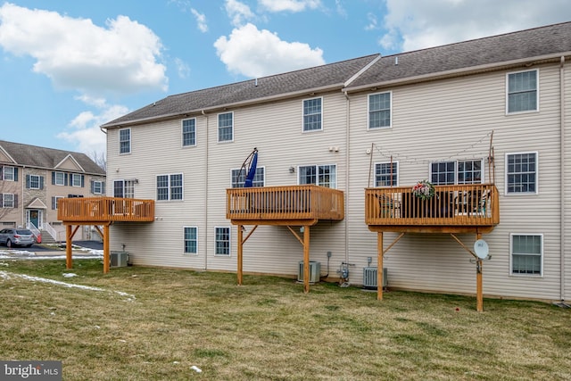 rear view of property with a yard and cooling unit