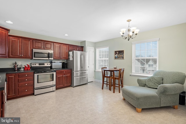 kitchen with plenty of natural light, a notable chandelier, and appliances with stainless steel finishes