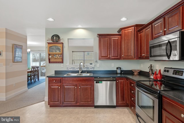 kitchen with light carpet, sink, and appliances with stainless steel finishes