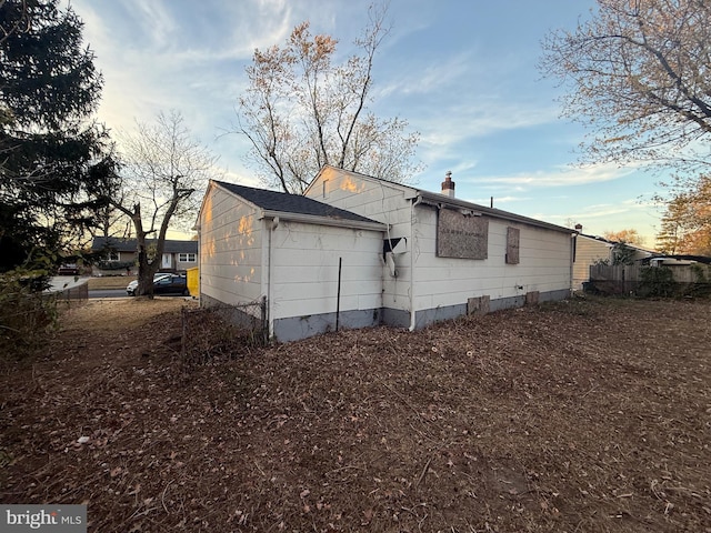 view of back house at dusk