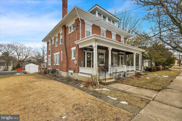 view of front of home featuring an outbuilding and a porch