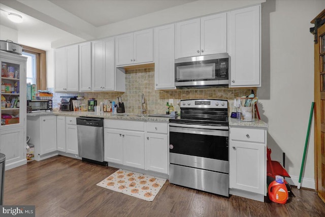 kitchen featuring white cabinets, decorative backsplash, sink, and stainless steel appliances