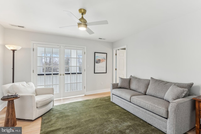 living room with french doors and ceiling fan