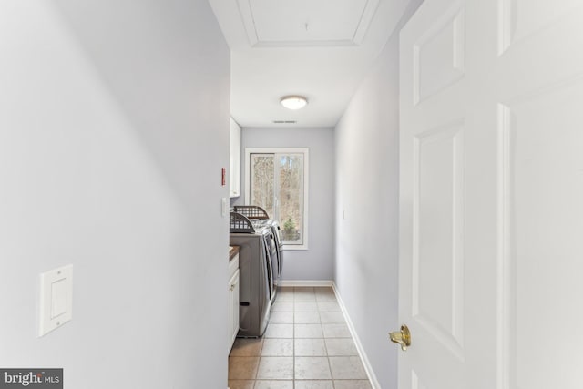 washroom with washing machine and dryer and light tile patterned floors