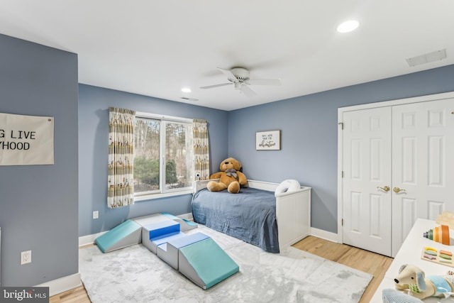 bedroom with hardwood / wood-style floors, a closet, and ceiling fan