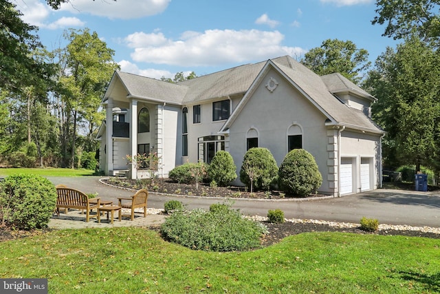 view of side of property with a garage and a lawn