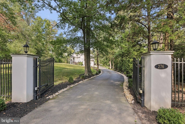 view of gate featuring a yard