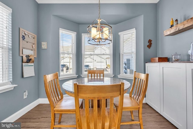 dining space with dark hardwood / wood-style floors and a chandelier