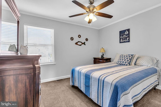 carpeted bedroom with ceiling fan and ornamental molding