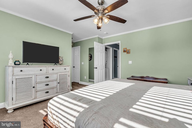 carpeted bedroom with ceiling fan and ornamental molding