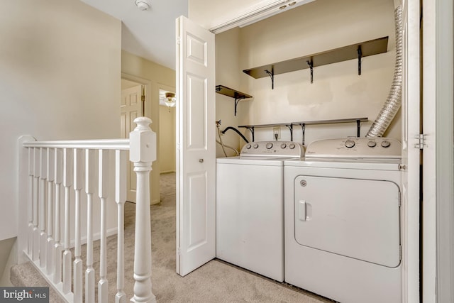 laundry room with light colored carpet and washer and clothes dryer