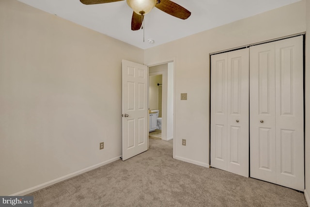 unfurnished bedroom featuring a closet, ceiling fan, and light colored carpet