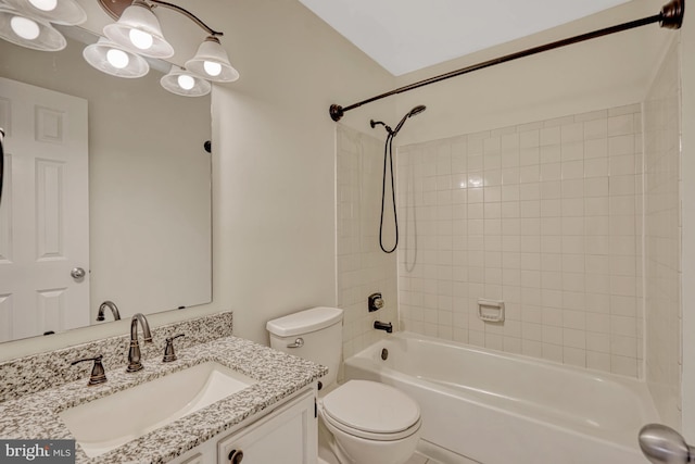 full bathroom featuring toilet, vanity, and tiled shower / bath